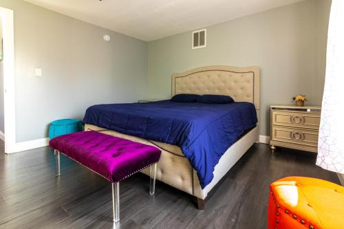 a bedroom with a bed with a purple comforter at The Prospect Point Penthouse- Yard & Parking, Minutes From Falls & Casino by Niagara Hospitality in Niagara Falls