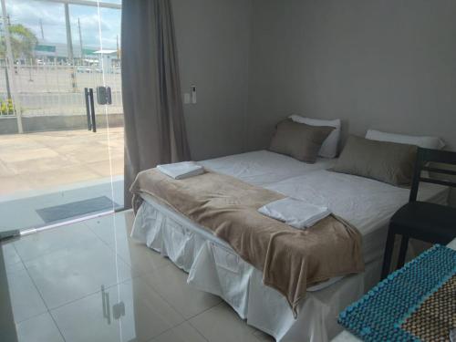 a bedroom with a bed with two towels on it at Barcel Flat in Teresina