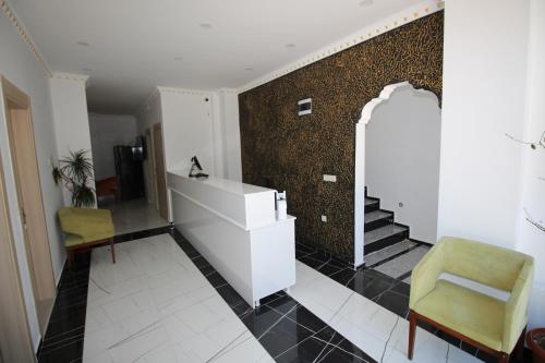a room with a desk and a chair and a wall at Piri Reis Butik Hotel in Marmara