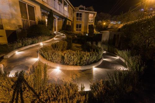 a garden with lights on a street at night at Hotel Boutique Rosario Sur in La Paz