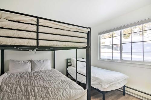 a bedroom with two bunk beds and a window at The Cottages Ski-InandSki-Out Condo at Eagle Point! in Beaver