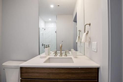 a white bathroom with a sink and a toilet at Loop 1BR w Deck Gym WD nr W Loop the L CHI-220 in Chicago