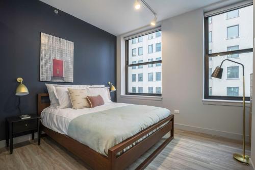 a bedroom with a bed and two windows at Loop 1BR wGym Roofdeck WD nr W Loop the L CHI-200 in Chicago