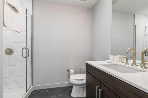 a bathroom with a toilet and a sink and a shower at Loop 1BR wGym Roofdeck WD nr W Loop the L CHI-200 in Chicago