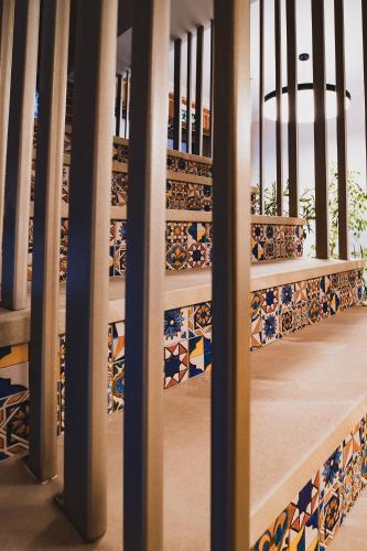 a stairwell with mosaics on the steps of a building at First Apartments in Focşani