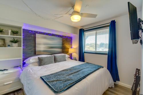 a bedroom with a large bed with purple lighting at Ocean Shores Condo Walk to the Beach! in Ocean Shores