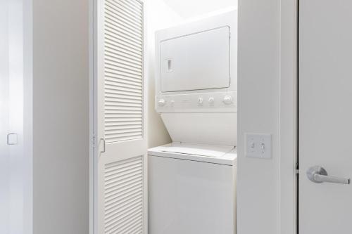 a kitchen with a refrigerator and a washer and dryer at Loop Studio w Pool Gym nr Theatre District CHI-272 in Chicago