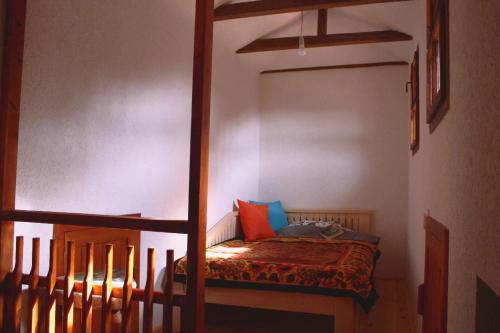 a bed in a room with a bunk bed at Traditional Cottage - Vila Samovila in Delčevo