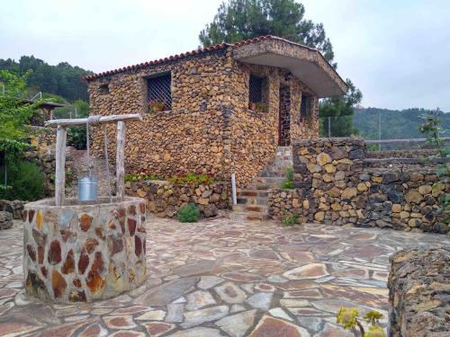 a stone house with a stone staircase and a stone wall at LA TAGORA Conect with the nature & relax in Icod de los Vinos