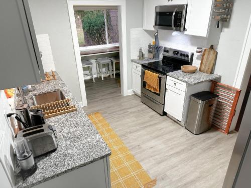 a kitchen with a sink and a stove top oven at IvyLand Pines in Cleveland Heights