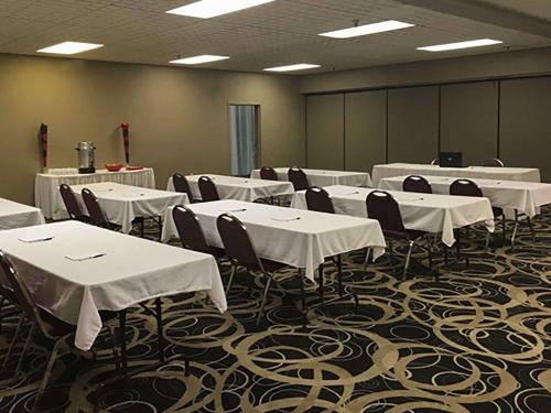 a conference room with white tables and chairs in it at Quality Inn Montpelier in Montpelier