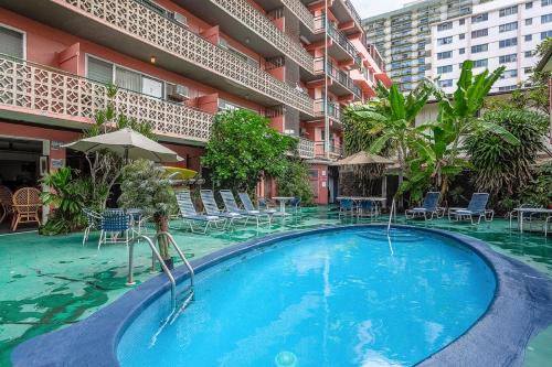 a swimming pool in front of a building at Royal Grove Waikiki in Honolulu