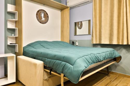 a bed with a green comforter in a room at Apollo 3 - Luxury Apartment (City Center Studio) in Katerini