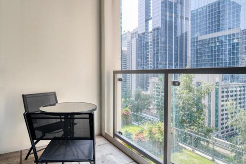 a table and chair in a room with a large window at Loop Studio w gym pool lounge 1 block from L CHI-694 in Chicago