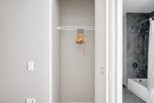 a white bathroom with a shower and a tub at Loop Studio w gym pool lounge 1 block from L CHI-694 in Chicago