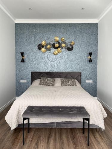 a bedroom with a large bed and a wall at Danes23 - Self Check-in, Free Parking, Park and River View, Oldtown in Klaipėda