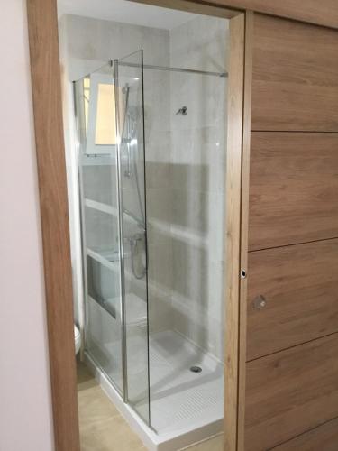 a shower with a glass door in a bathroom at App.Pradomar Peñiscola in Peniscola