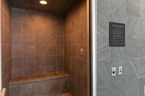a bathroom with a shower with a glass door at Loop 1BR w gym pool lounge 1 block from L CHI-700 in Chicago