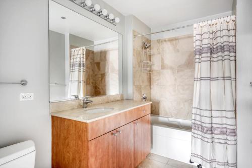 a bathroom with a sink and a mirror at South Loop 1br w gym lounge nr Grant Park CHI-847 in Chicago