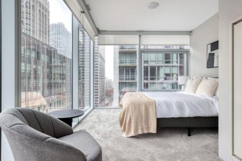 a bedroom with a bed and a large window at Streeterville 2br w pool gym nr Riverwalk CHI-880 in Chicago