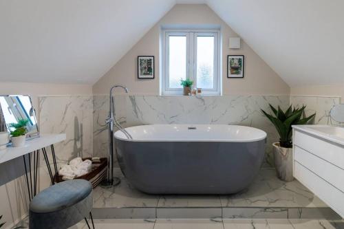a bathroom with a large tub in a attic at Roseland Apartment 5 in Arundel