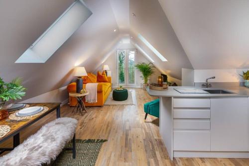 a kitchen and living room with an attic at Penthouse Apartment Arundel in Arundel