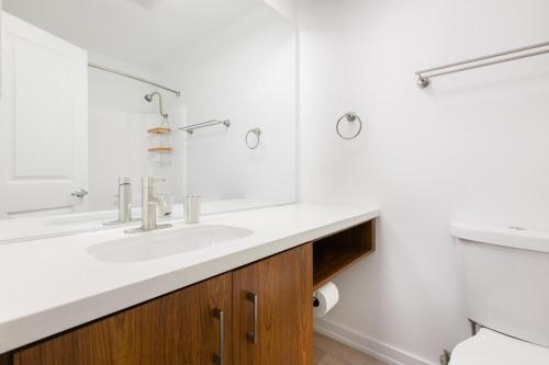a white bathroom with a sink and a toilet at Redondo Beach 1BR w Pool Gym nr Beach LAX-396 in Redondo Beach