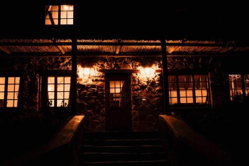 an old building with lights in the dark at Stone House McGregor in McGregor