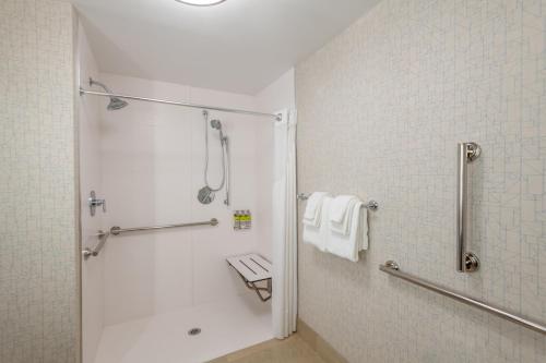 a white bathroom with a shower and a toilet at Holiday Inn Express & Suites - Phoenix - Airport North by IHG in Phoenix