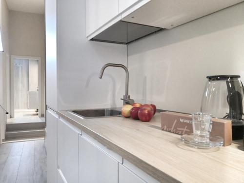 a kitchen with a sink and apples on a counter at [Luxury apartment near Niguarda] Graziano39 in Milan