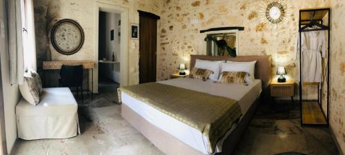 a bedroom with a large bed in a room at Gaia Luxury Rooms in Rethymno Town