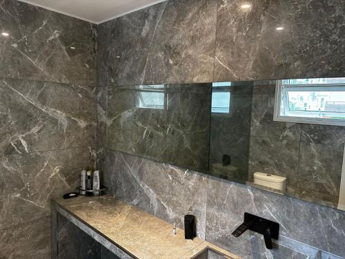 a bathroom with a sink and a mirror at Purobaires Hotel Boutique in Buenos Aires