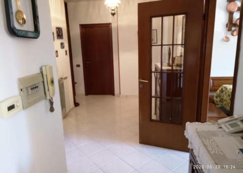 a hallway with a door and a phone in a room at Casa Mirna in Carrara