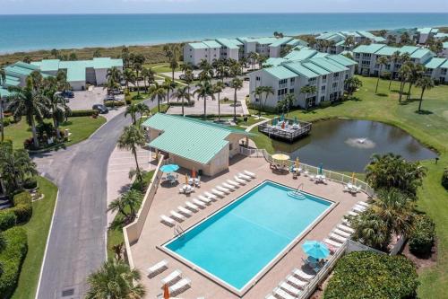 an aerial view of a resort with a swimming pool at Beachfront paradise Ocean Village Golf Tennis Several heated pools Tiki bar Pickleball insite sports bar and restaurant and much more in Fort Pierce