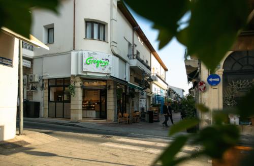 a man walking down a street in front of a store at Metropole Hotel in Limassol