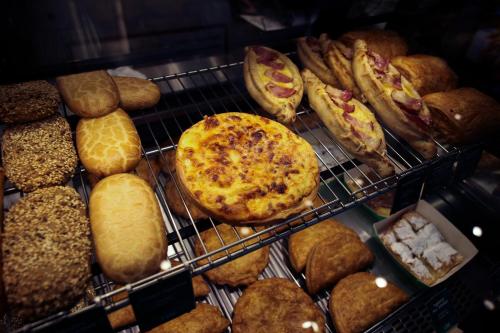 a display case filled with lots of different types of bread at Metropole Hotel in Limassol