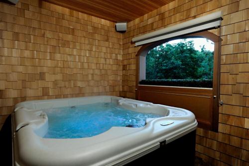 a large bath tub in a room with a window at The Wentworth in Jackson