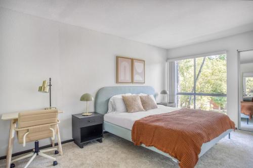 a bedroom with a bed and a desk and a window at Pasadena 2BR w Gym Pool nr Colorado Ave LAX-864 in Pasadena