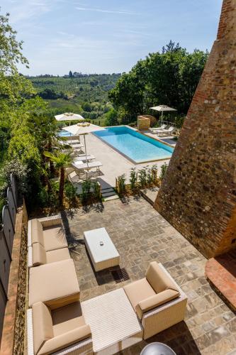 a resort with a pool and lounge chairs at Villa Pianora in Tavarnelle in Val di Pesa