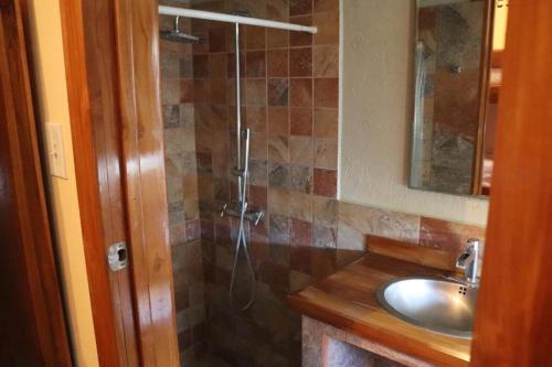 a bathroom with a shower and a sink at Planet B Hostel - Adults Only in Manuel Antonio