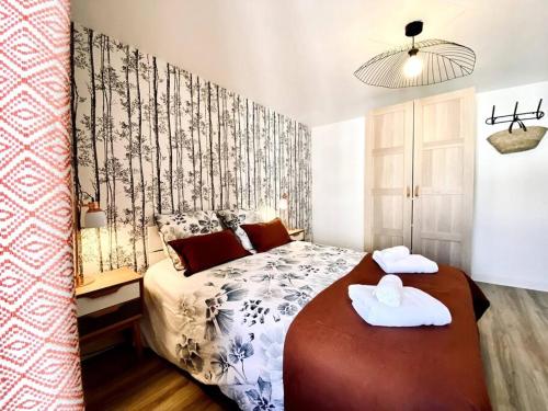 une chambre avec un lit avec deux serviettes dessus dans l'établissement Coquet F3 pour 4 pers 2 chambres proche centre-ville et gare, à Vichy