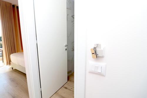 a white door in a room with a bedroom at Fegi Rooms in Himare