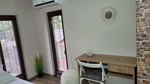 a bedroom with a desk and a chair in a room at Palatinus Apartman Esztergom in Esztergom