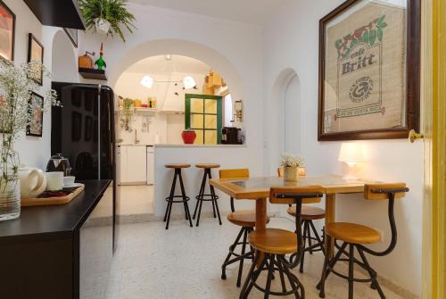 a kitchen with a table and stools in a room at Your Vintage Townhouse in Lagos