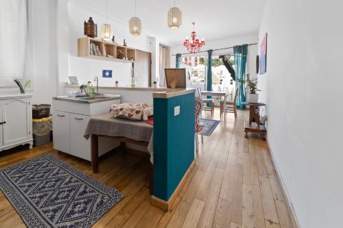 a kitchen and living room with a blue island in the middle at Domus Karalis in Cagliari