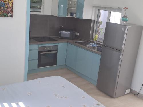 a kitchen with a refrigerator and a stove at Tropical in Orient Bay French St Martin