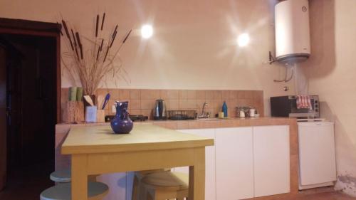 a kitchen with a table with a blue vase on it at Cabañas Sixilera in Huacalera
