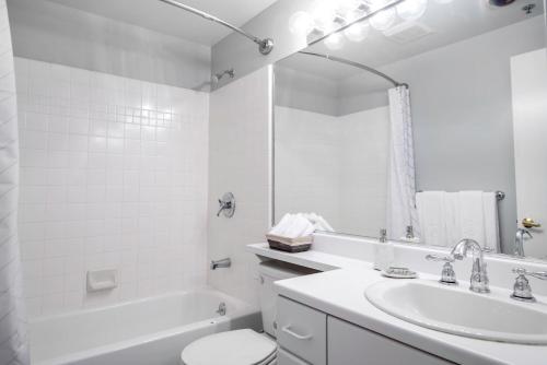 a white bathroom with a sink and a toilet and a tub at Telegraph Hill Studio wSpa nr Coit Tower SFO-38 in San Francisco
