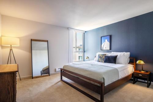 a bedroom with a large bed with a blue wall at N Beach 1BR w Pool Fitness Center nr Muni SFO-233 in San Francisco