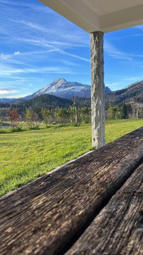 a porch with a view of a field and mountains at Ferienvilla Joachimsberg mit Swimspa und Sauna in Wienerbruck